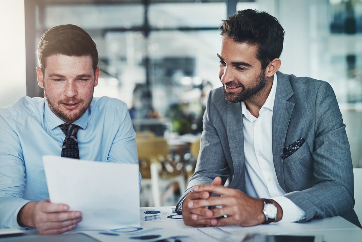 two team members talking together