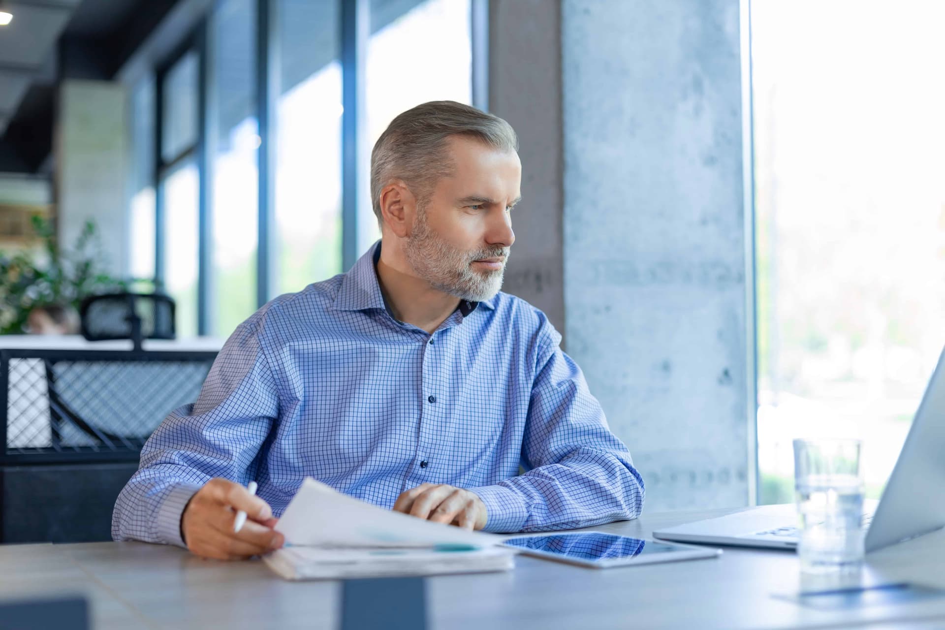 Businessman working with documents using laptop